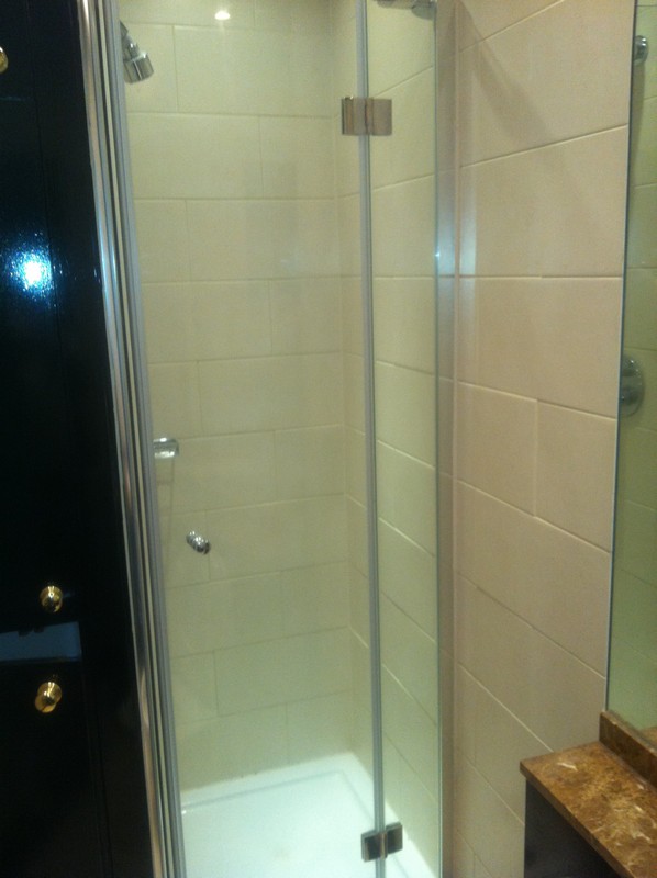 Frameless glass shower enclosure with chrome fittings in Westcombe Park