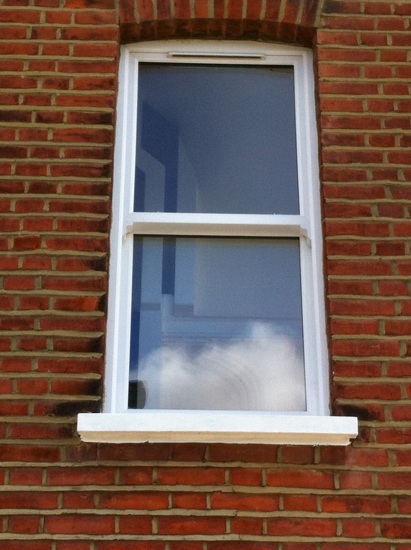 uPVC sash window on Victorian red brick house in Westcombe Park